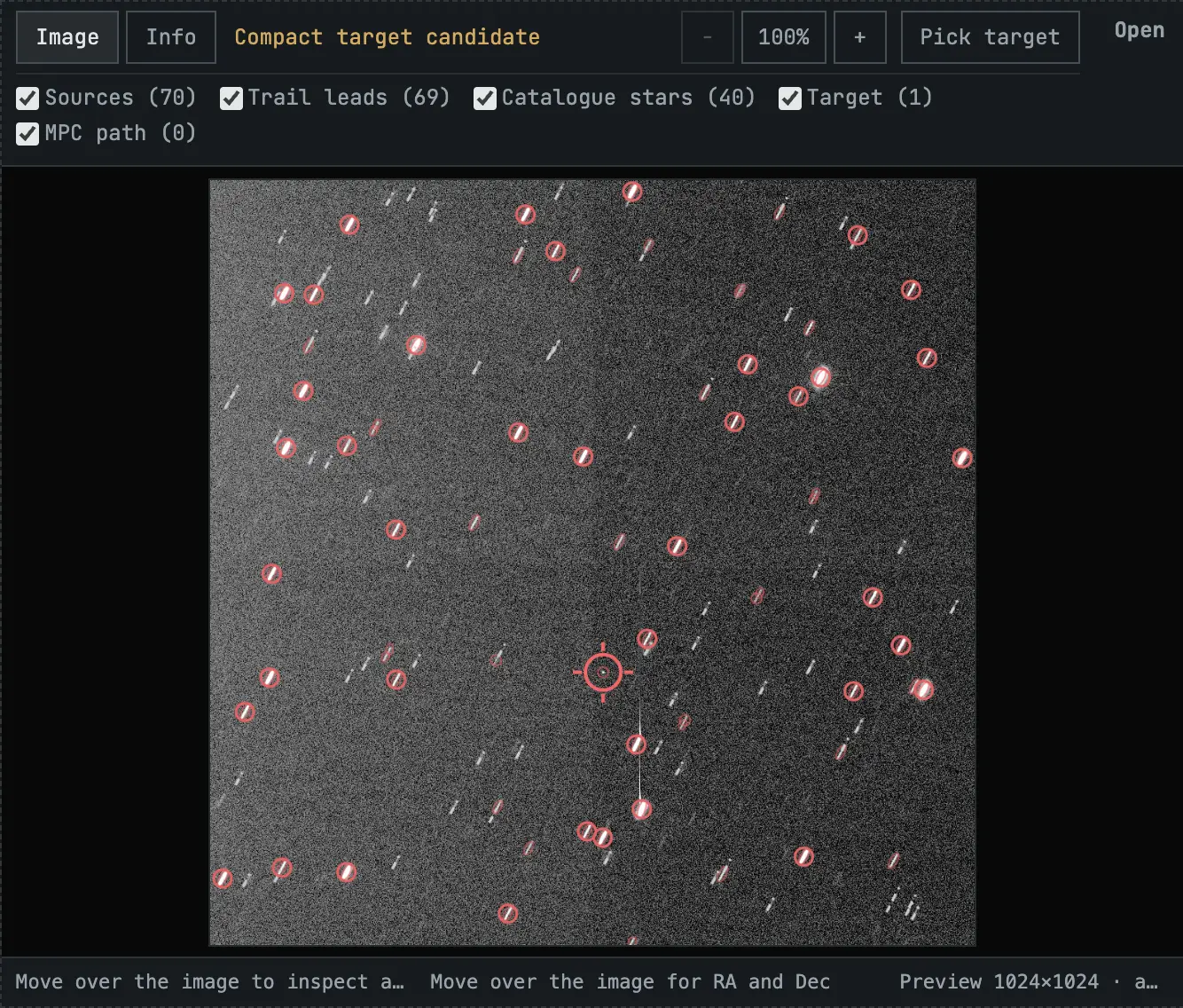 A frame with stellar trails circled in red and one round target candidate marked by a cross-hair.